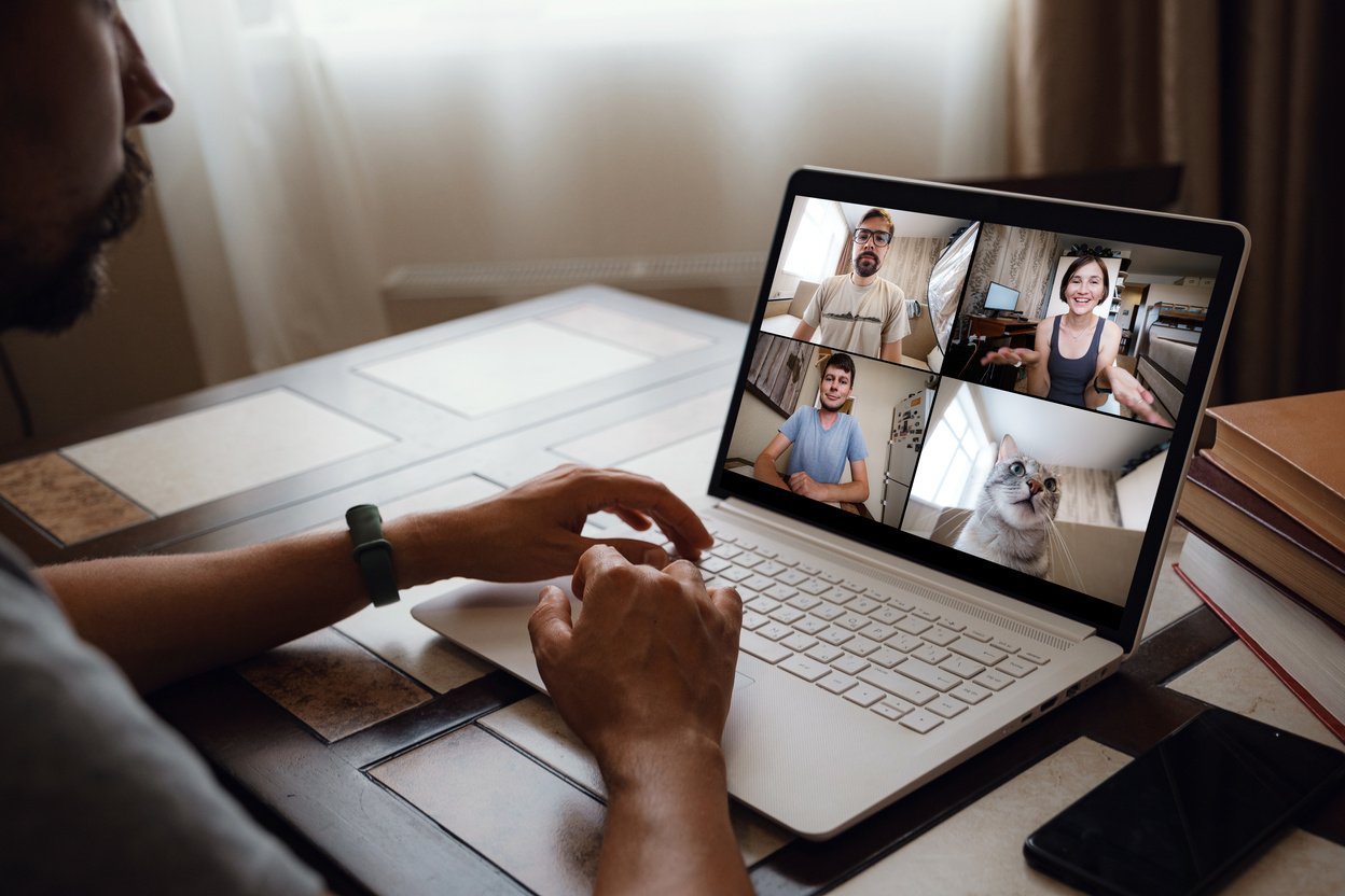 Man Working From Home Having Online Group Videoconference On Laptop